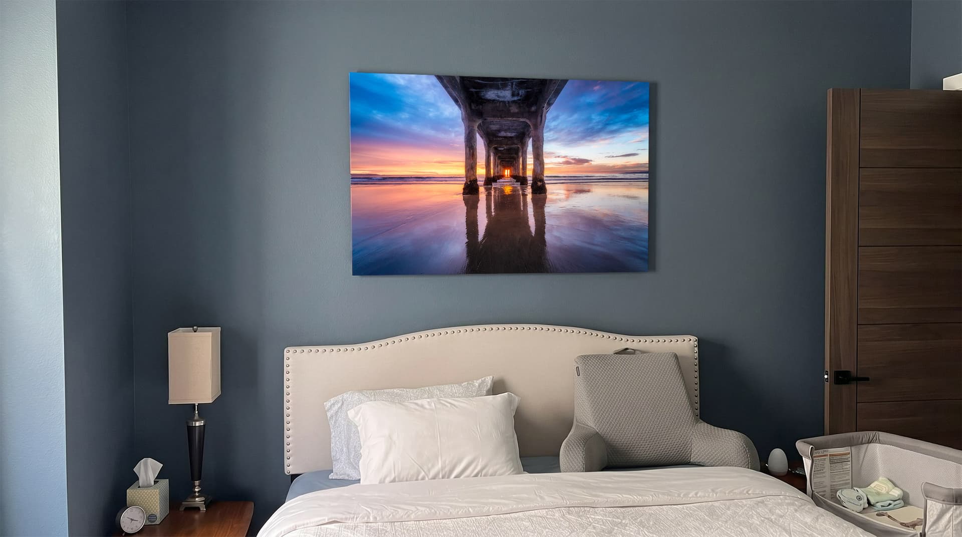Under, Manhattan Beach Pier print hanging above a bed